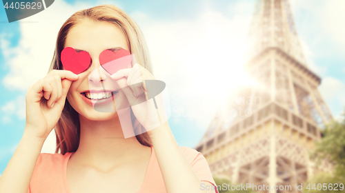 Image of happy young woman with red heart shapes on eyes