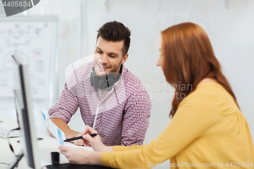 Image of creative team with headphones and computer