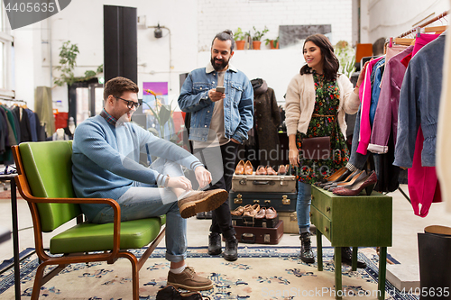 Image of friends choosing clothes at vintage clothing store