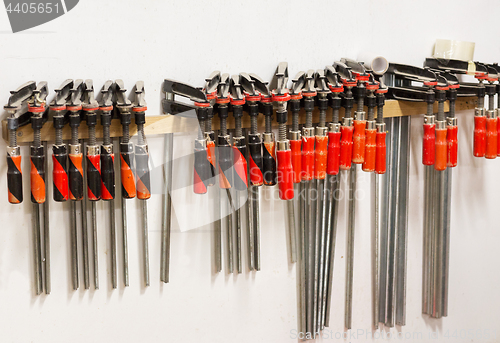 Image of one-handed bar clamps hanging on wall