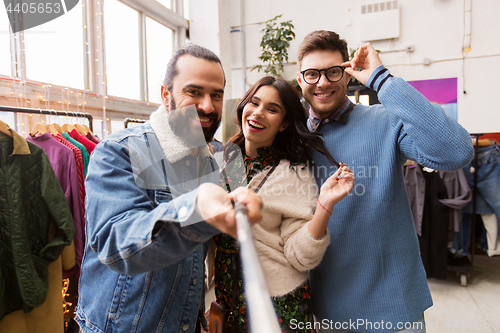 Image of friends taking selfie at vintage clothing store