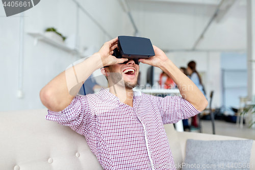 Image of happy man with virtual reality headset at office