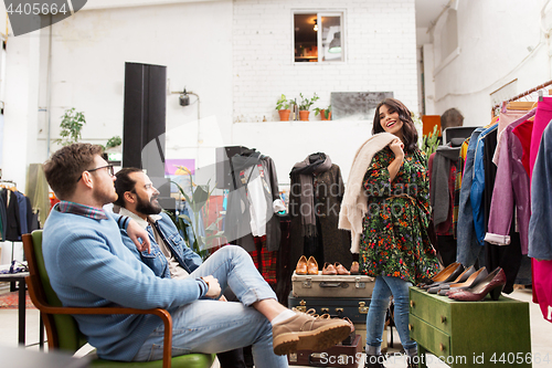 Image of friends choosing clothes at vintage clothing store