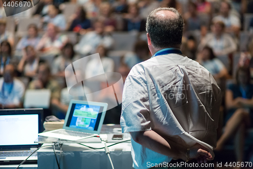 Image of Public speaker giving talk at Business Event.