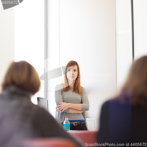 Image of Woman giving presentation in lecture hall at university.