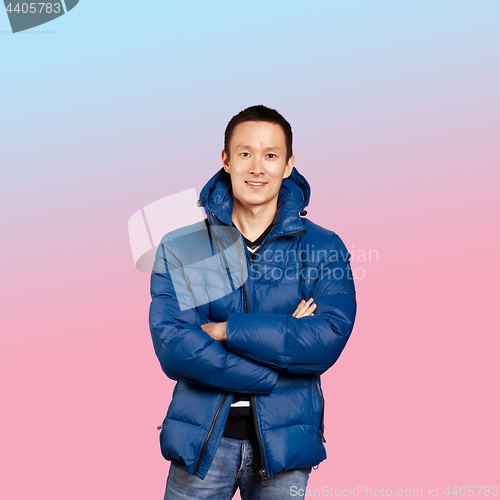 Image of Asian man in blue down-padded coat