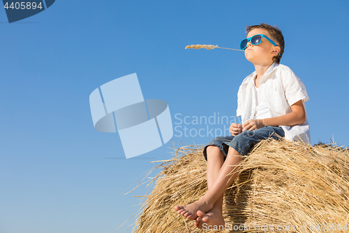 Image of Happy little boy playing in the park at the day time.