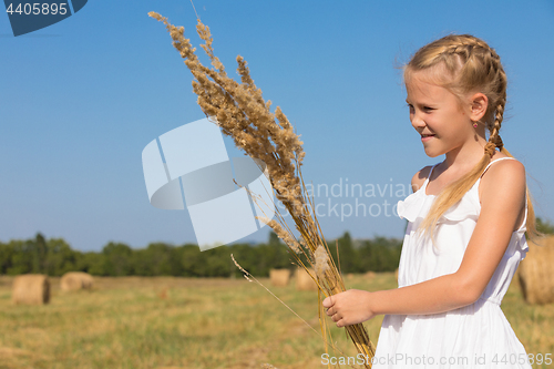 Image of Happy little girl playing in the park at the day time.