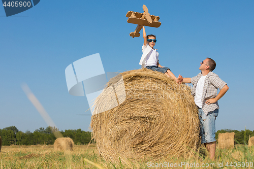 Image of Father and son playing in the park at the day time.