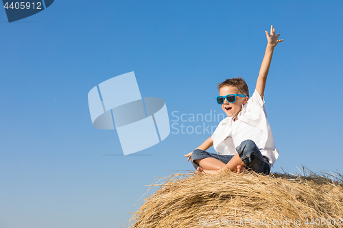 Image of Happy little boy playing in the park at the day time.