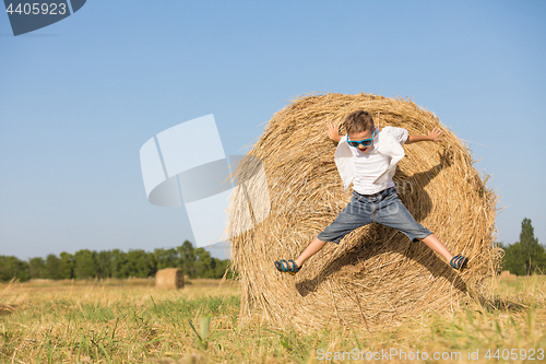 Image of Happy little boy playing in the park at the day time.