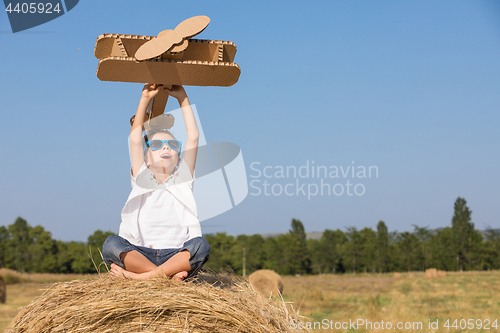 Image of Happy little boy playing in the park at the day time.