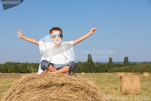 Image of Happy little boy playing in the park at the day time.