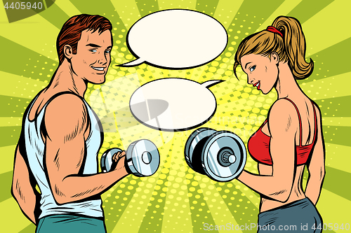 Image of Man and woman in the gym with dumbbells