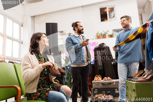 Image of friends choosing clothes at vintage clothing store