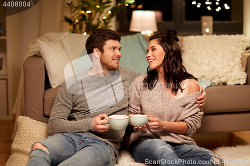 Image of happy couple drinking cacao at home