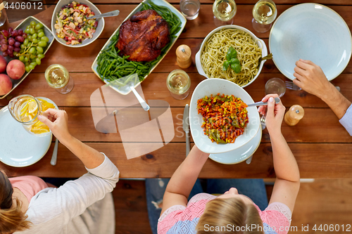 Image of group of people eating at table with food