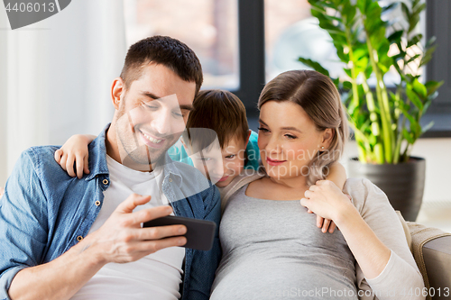 Image of happy family with smartphone at home