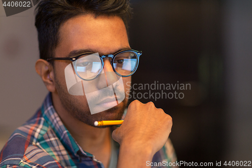 Image of close up of creative man working at night office