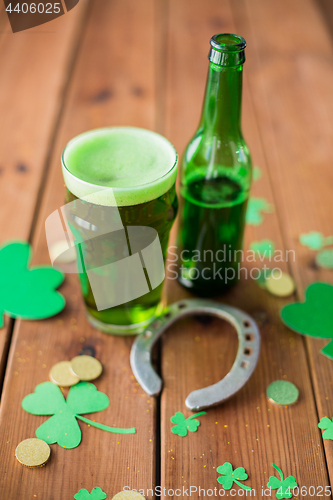 Image of glass of green beer, horseshoe and gold coins