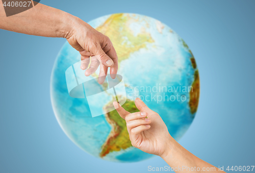 Image of close up of senior and young woman hands