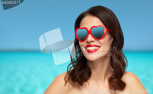 Image of woman with red lipstick and heart shaped shades