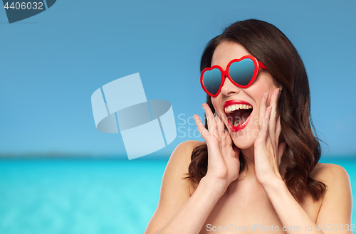 Image of woman with red lipstick and heart shaped shades