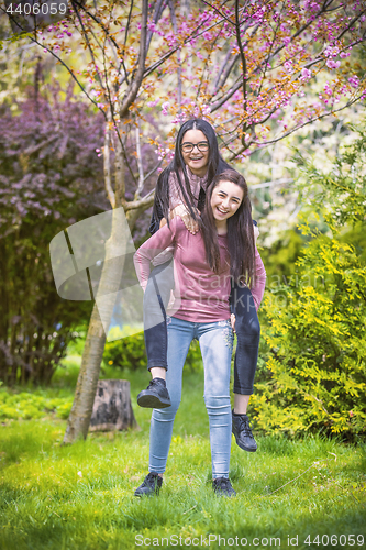 Image of Two sisters having fun in the park