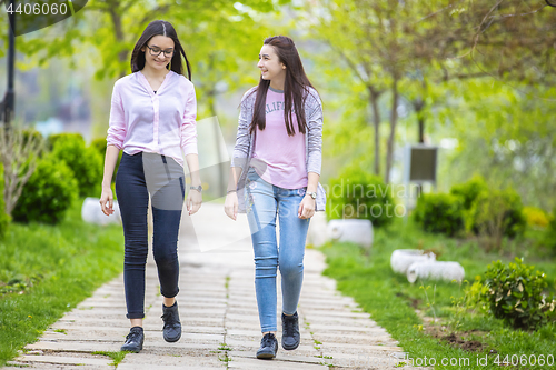 Image of Two sisters having fun in the park