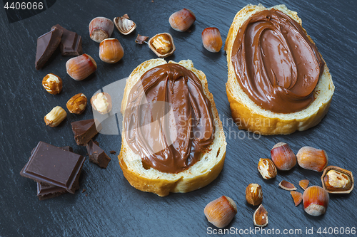 Image of Two bread slices with chocolate hazelnut spread