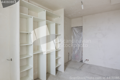 Image of Repair in the living room of a new building, built-in wardrobe and closed by a cloth entrance to the room