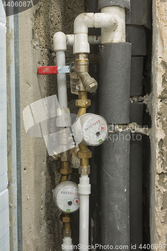 Image of Not sealed hot and cold water meters in a new building