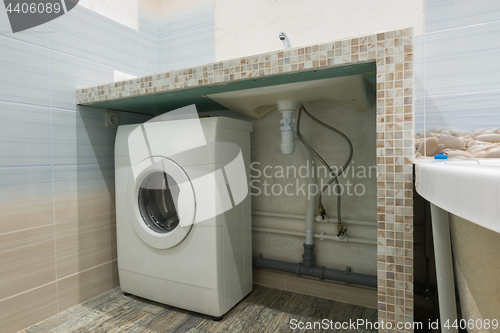 Image of Homemade pedestal in the washbasin in the bathroom, space for a washing machine