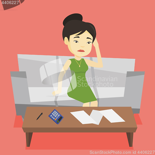 Image of Unhappy asian woman accounting home bills.