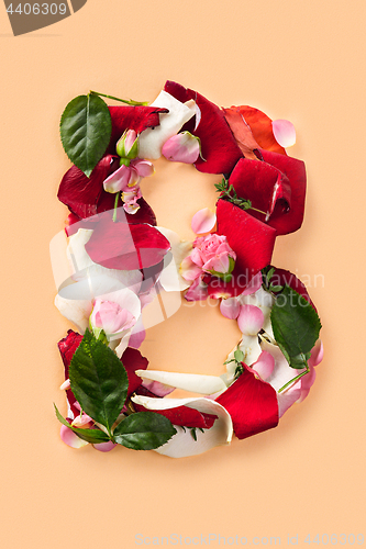 Image of Letter B made from red roses and petals isolated on a white background