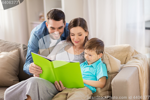 Image of happy family reading book at home