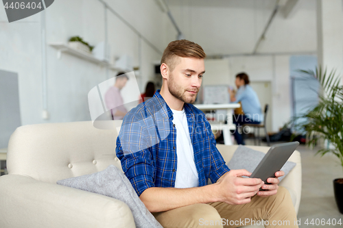 Image of man with tablet pc working at office