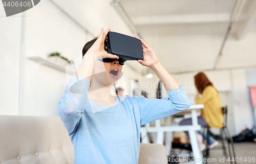 Image of happy woman with virtual reality headset at office