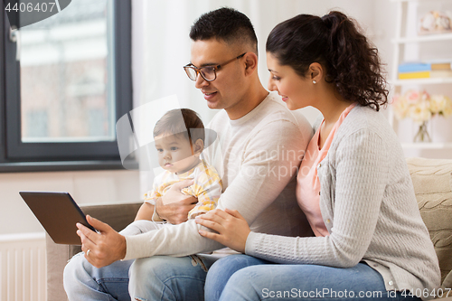 Image of mother, father and baby with tablet pc at home