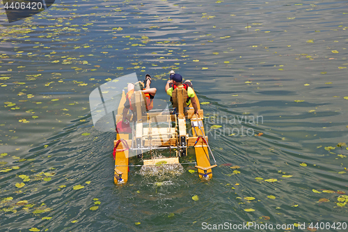 Image of Two man ride with floating pedal bicycle boats across the lake