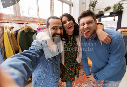 Image of friends taking selfie at vintage clothing store