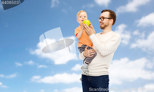 Image of happy father and little son with green apple