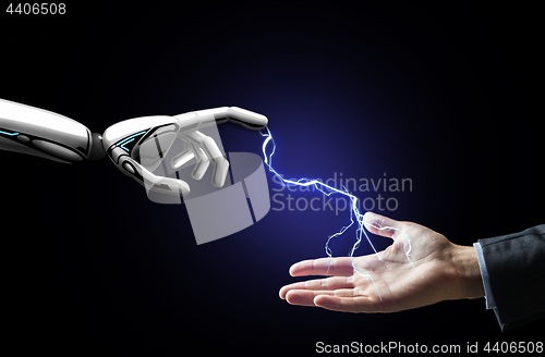 Image of robot and human hand connected by lightning