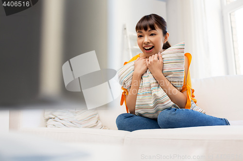 Image of happy asian woman with watching tv at home