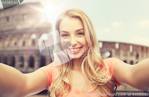 Image of happy smiling young woman taking selfie