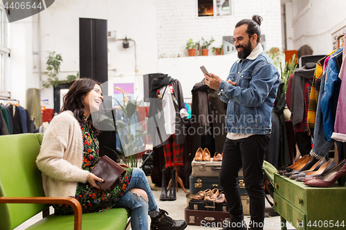 Image of couple choosing clothes at vintage clothing store