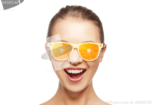 Image of happy teenage girl in sunglasses with oranges