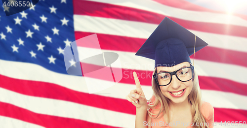 Image of smiling young student woman in mortarboard