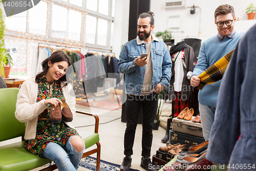 Image of friends choosing clothes at vintage clothing store