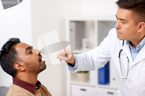 Image of doctor examining patient throat at clinic